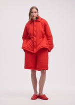 A model wears the ISSEY MIYAKE PUMPED T trousers.