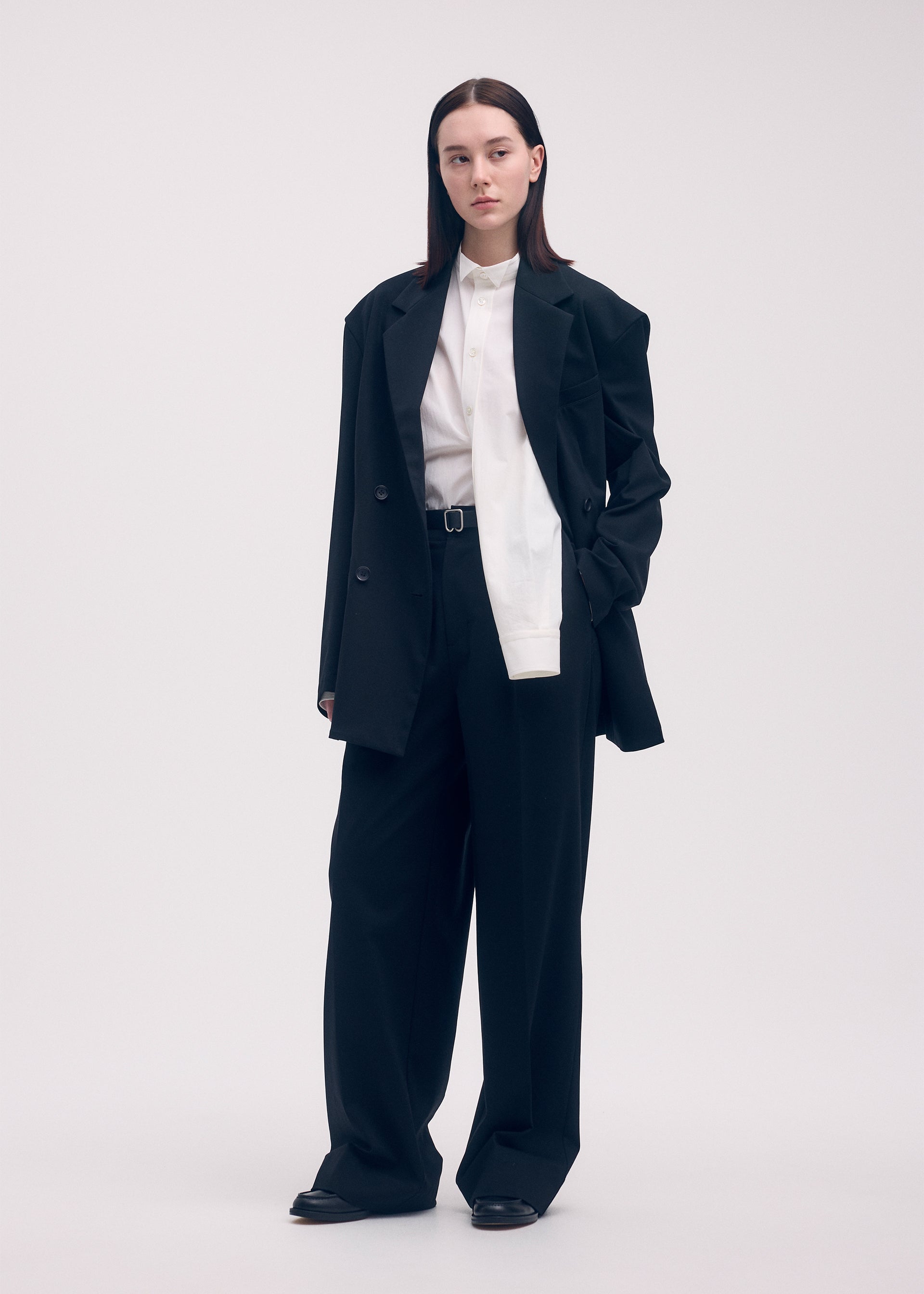A model wears the ISSEY MIYAKE SIMPLE ENSEMBLE trousers.