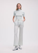 A model wears the ISSEY MIYAKE HANG OR CARRY trousers.