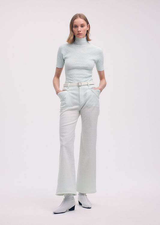 A model wears the ISSEY MIYAKE HANG OR CARRY trousers.