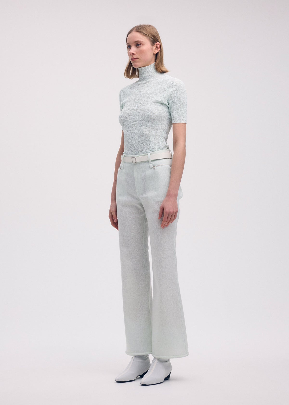A model wears the ISSEY MIYAKE HANG OR CARRY trousers.
