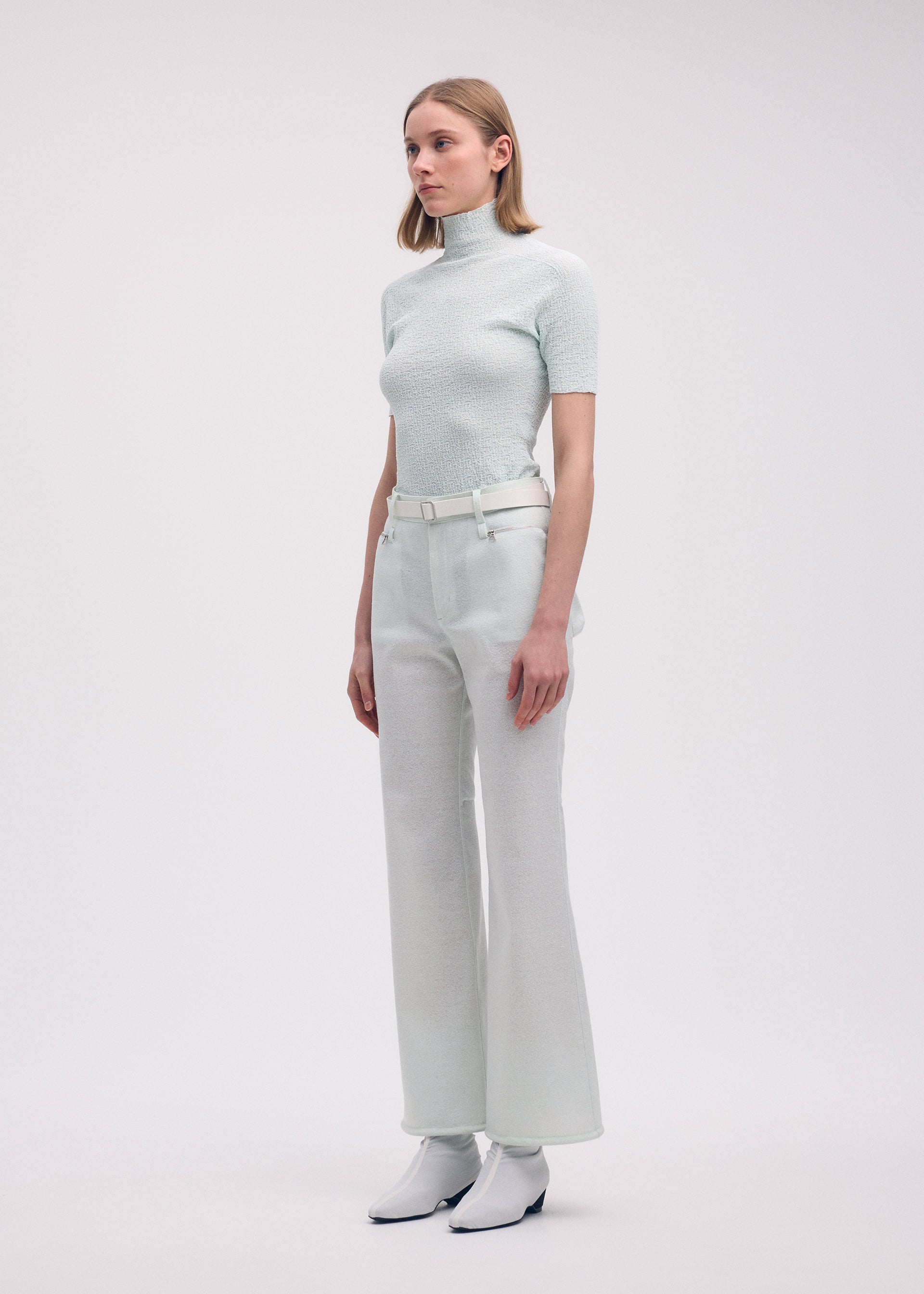 A model wears the ISSEY MIYAKE HANG OR CARRY trousers.