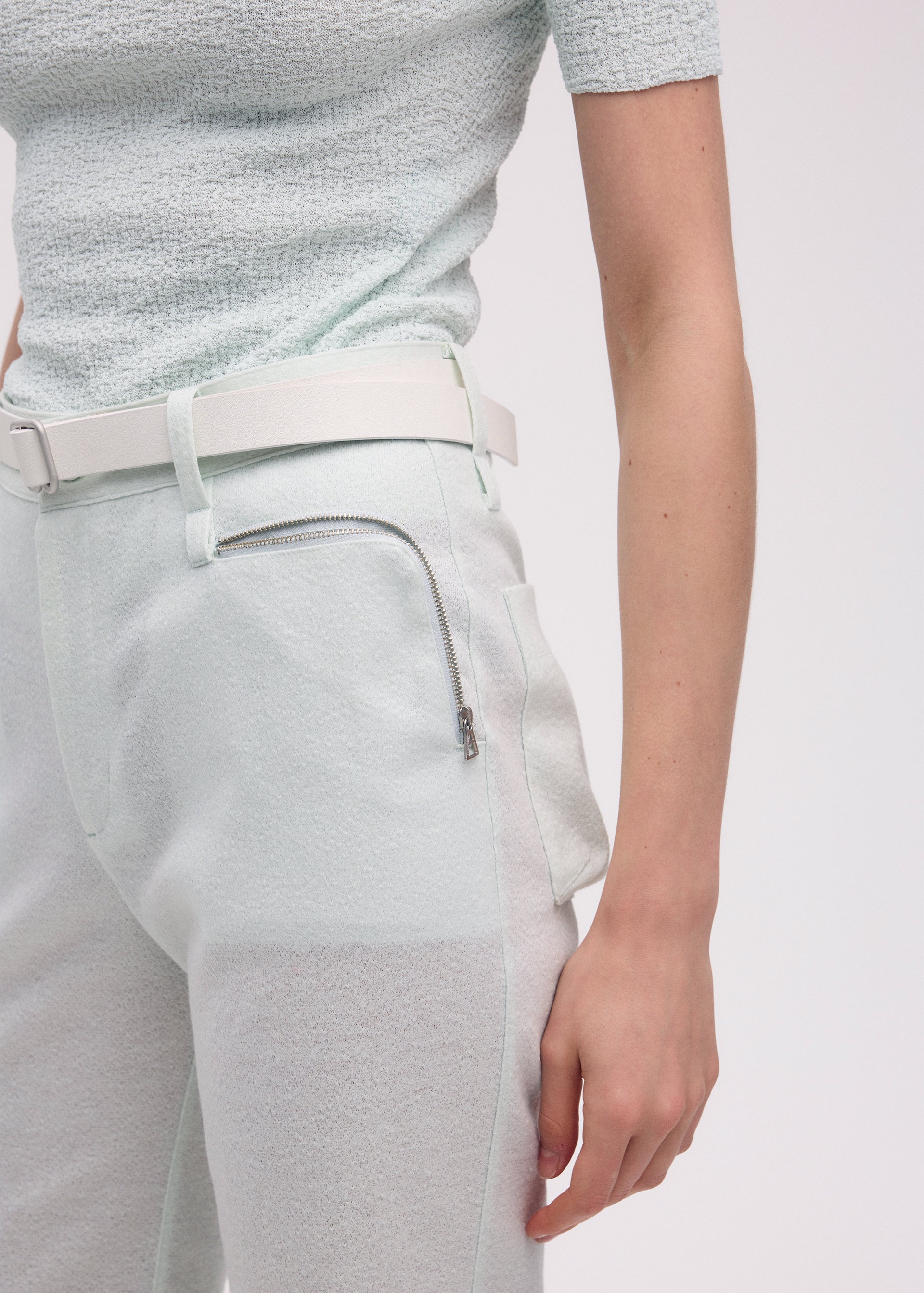 A model wears the ISSEY MIYAKE HANG OR CARRY trousers.