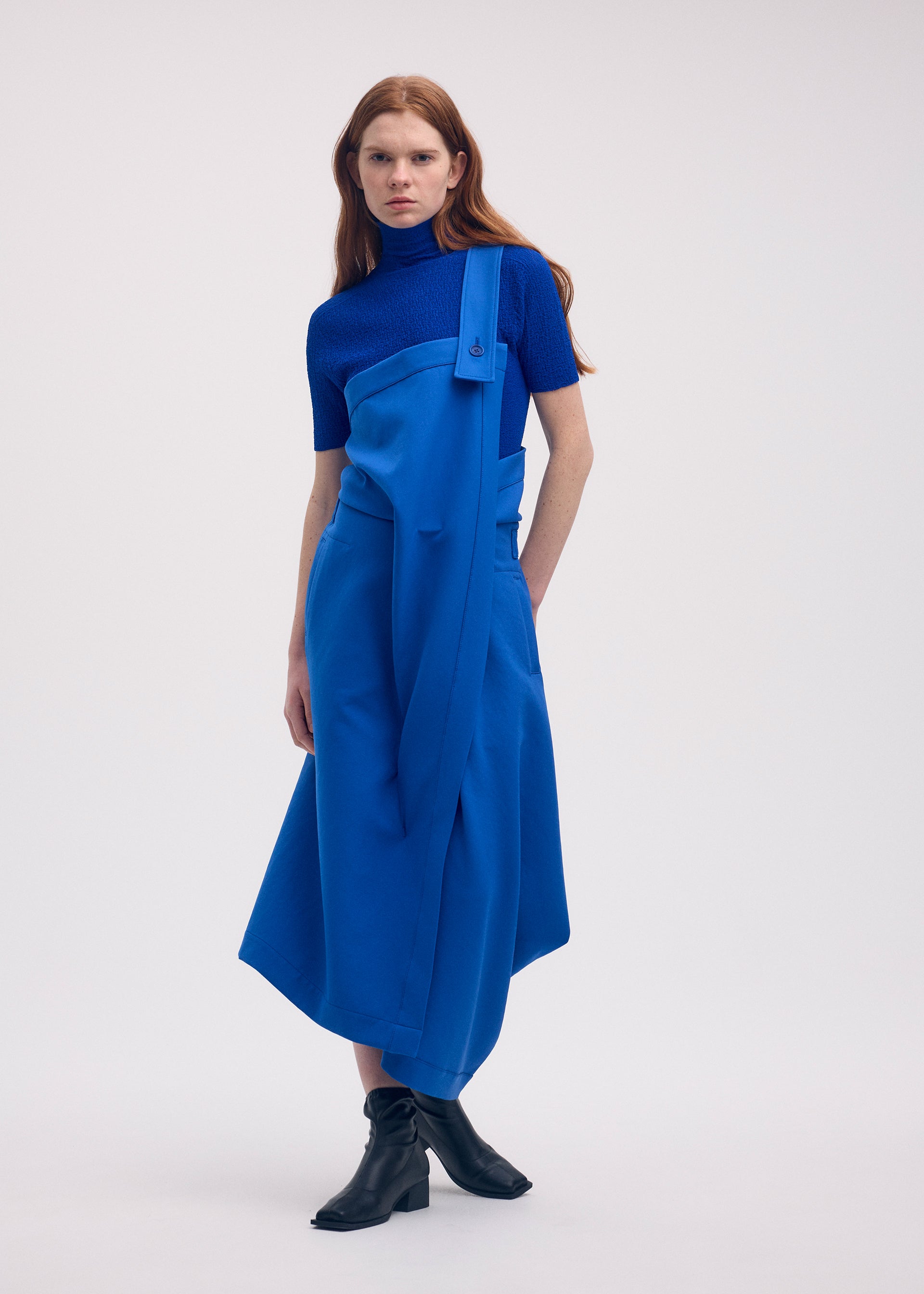 A model wears the ISSEY MIYAKE LEFT UNDONE trousers.