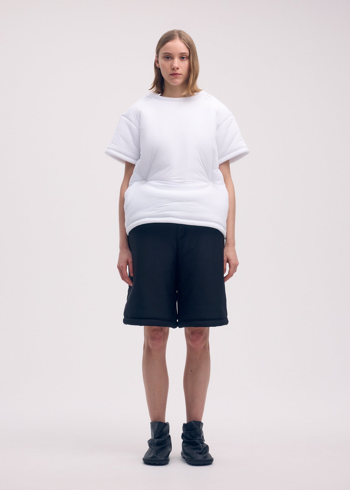A model wears the ISSEY MIYAKE PUMPED T top.