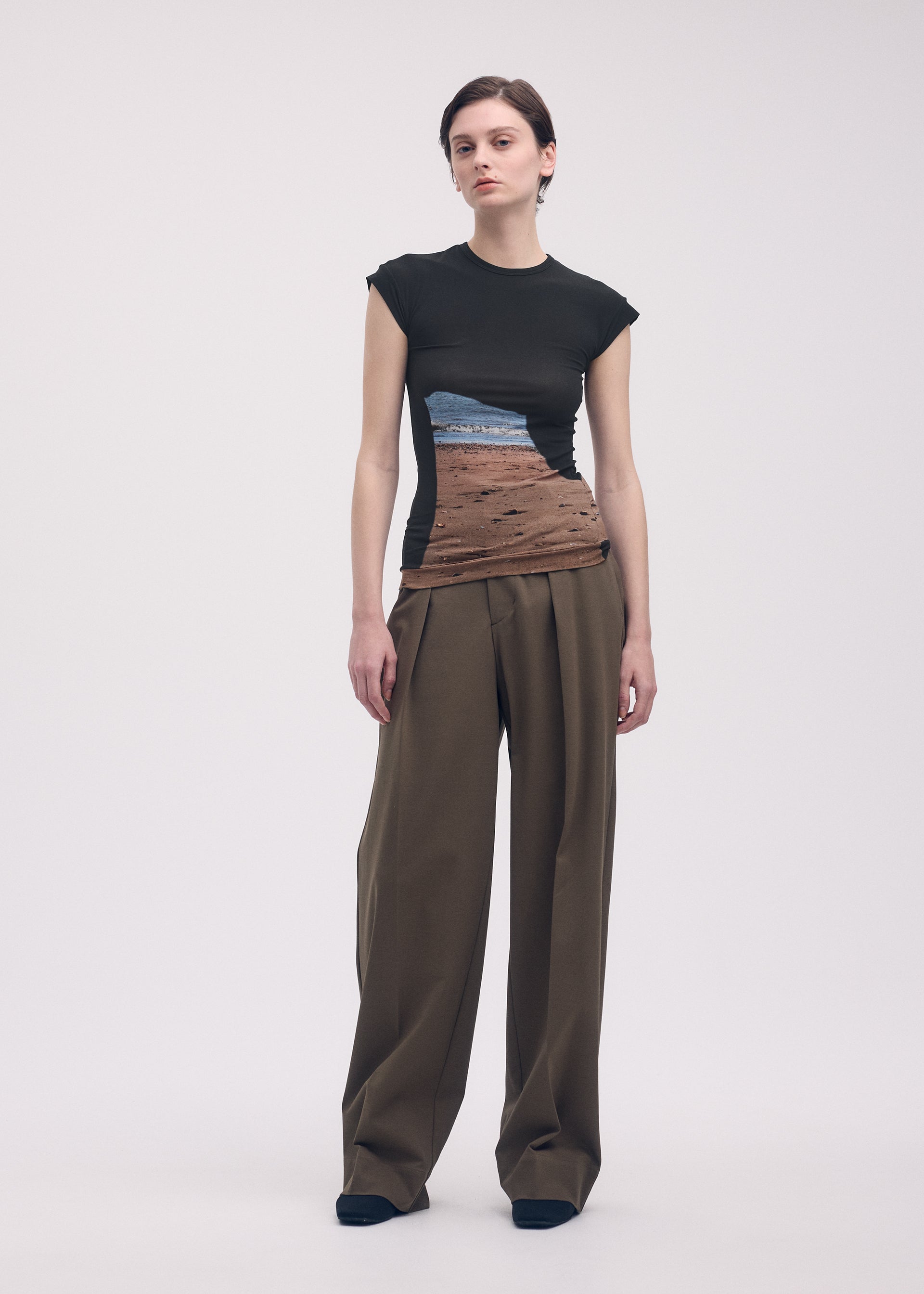 A model wears the ISSEY MIYAKE LIKE SKIN (AT SHORE) top.