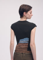 A model wears the ISSEY MIYAKE LIKE SKIN (AT SHORE) top.