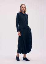 A model wears the ISSEY MIYAKE DRAPE JERSEY 58 top.