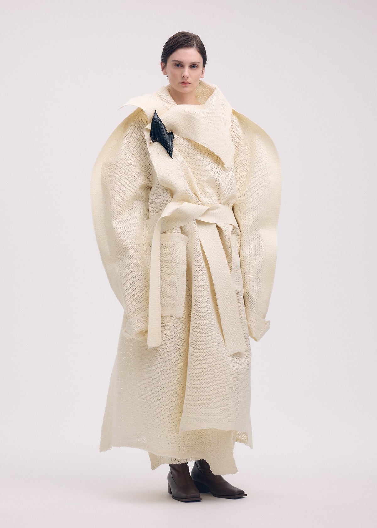 A model wears the ISSEY MIYAKE PANINI coat.