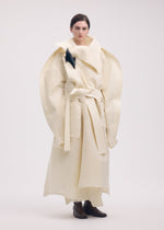 A model wears the ISSEY MIYAKE PANINI coat.