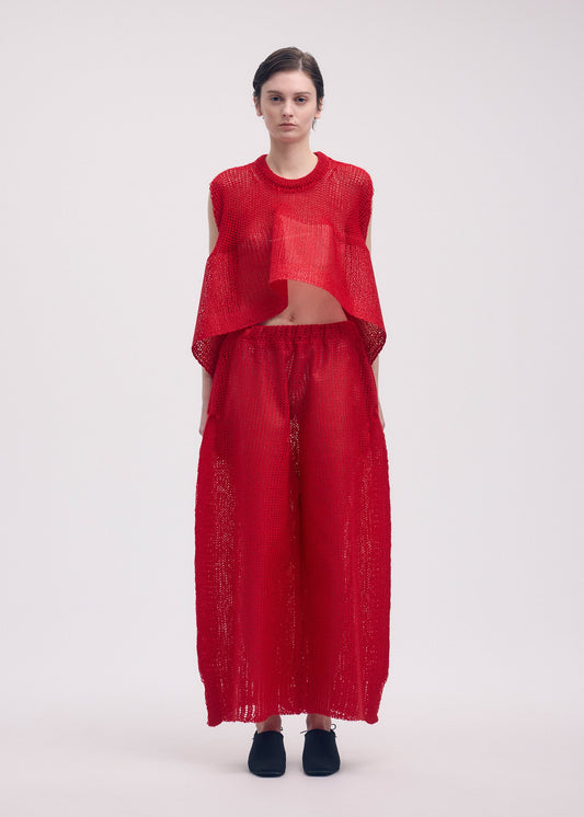 A model wears the ISSEY MIYAKE PANINI trousers.