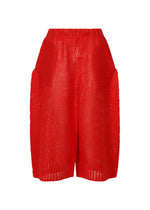 A product shot of the ISSEY MIYAKE PANINI trousers in red (24).