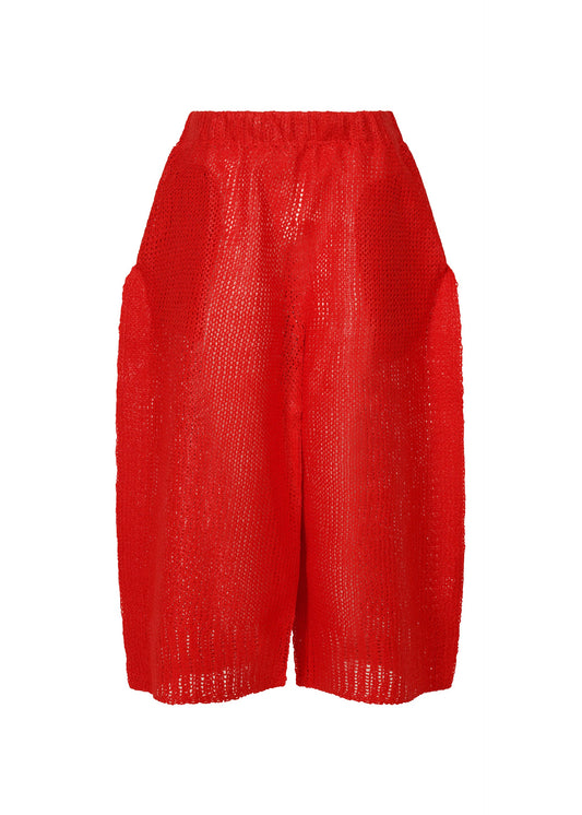 A product shot of the ISSEY MIYAKE PANINI trousers in red (24).