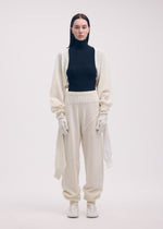A model wears the ISSEY MIYAKE SLEEVES COLLECTION trousers.