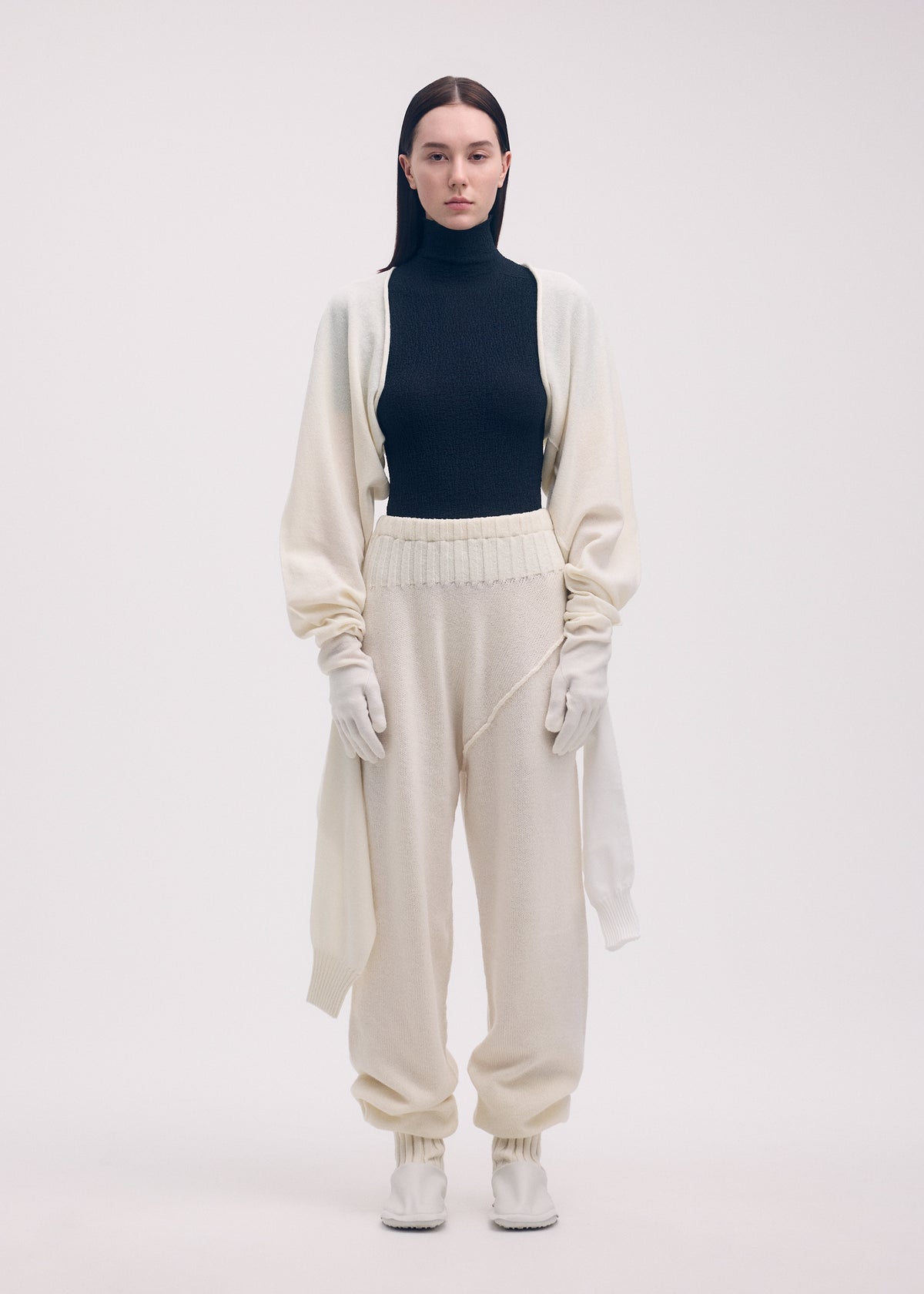 A model wears the ISSEY MIYAKE SLEEVES COLLECTION trousers.