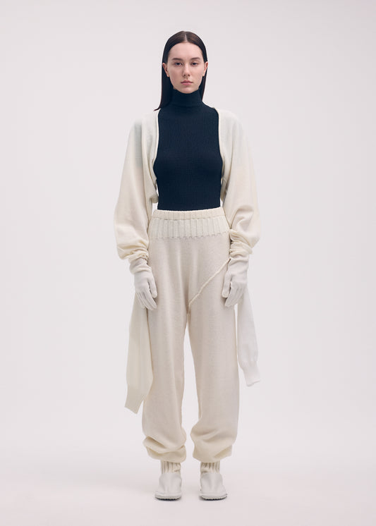 A model wears the ISSEY MIYAKE SLEEVES COLLECTION trousers.