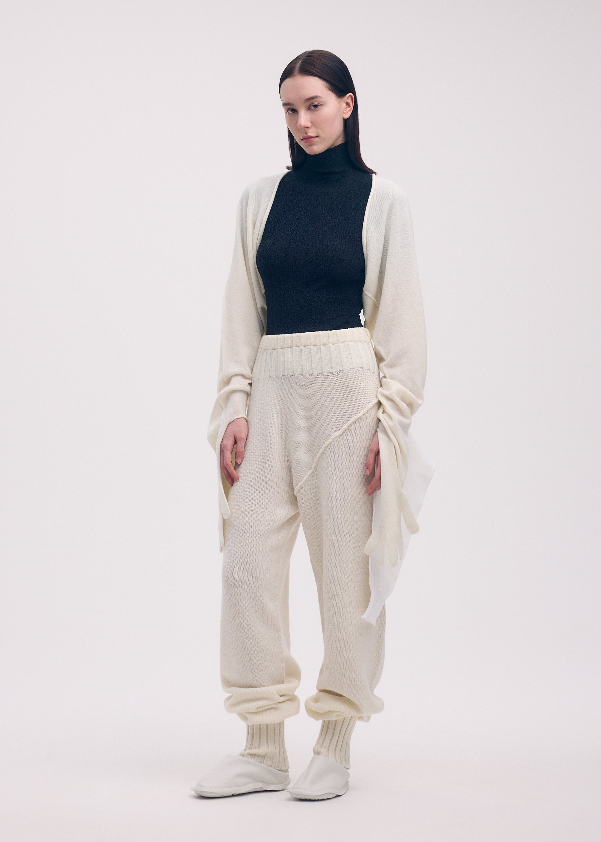 A model wears the ISSEY MIYAKE SLEEVES COLLECTION trousers.