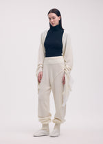 A model wears the ISSEY MIYAKE SLEEVES COLLECTION trousers.