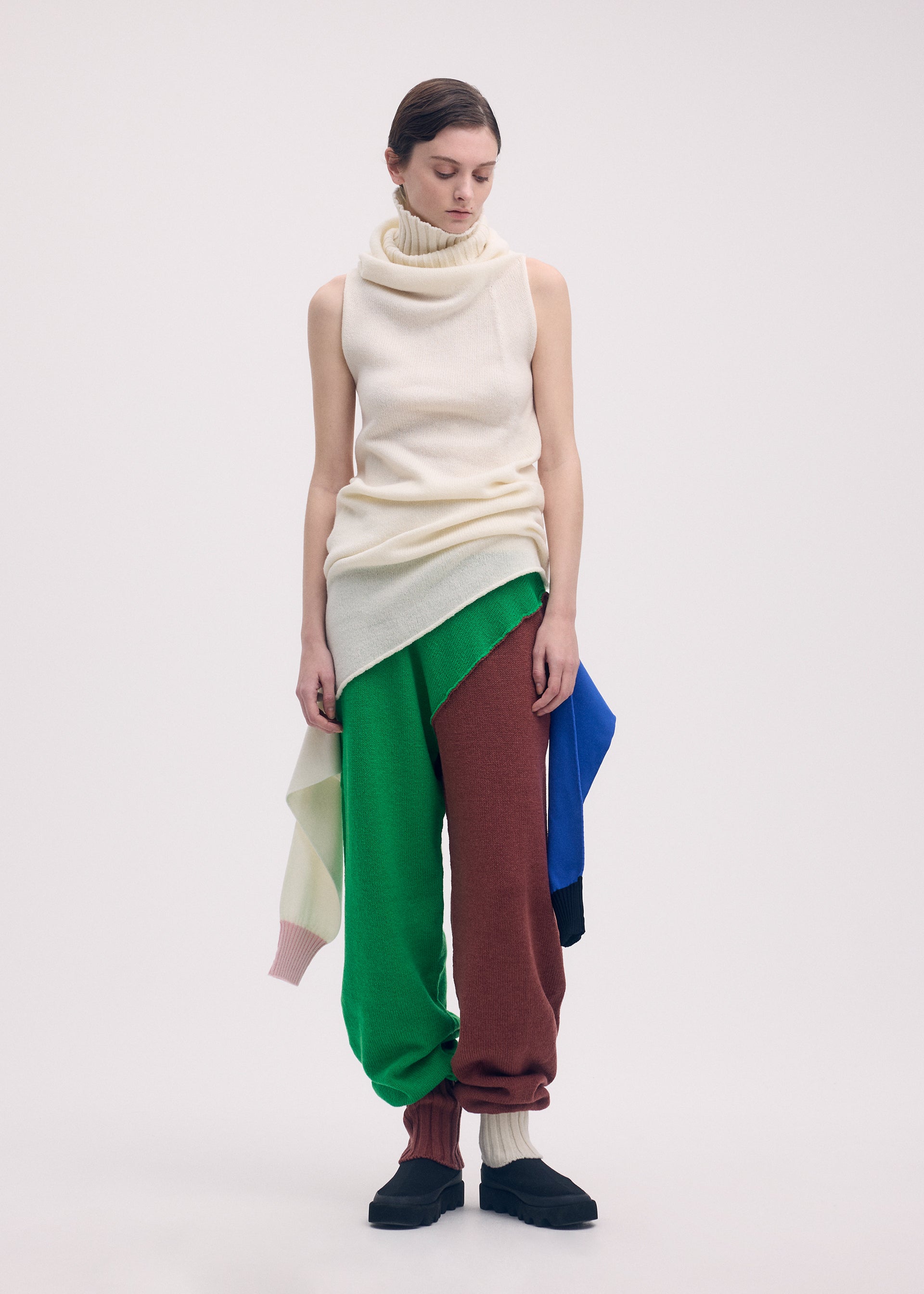 A model wears the ISSEY MIYAKE SLEEVES COLLECTION trousers.