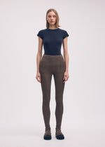 A model wears the ISSEY MIYAKE ODD PANTS trousers.