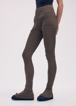 A model wears the ISSEY MIYAKE ODD PANTS trousers.