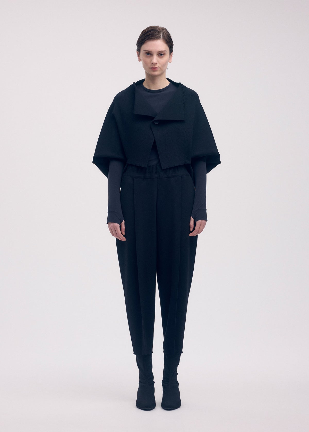 A model wears the ISSEY MIYAKE CAMPAGNE trousers.