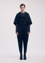 A model wears the ISSEY MIYAKE CAMPAGNE trousers.