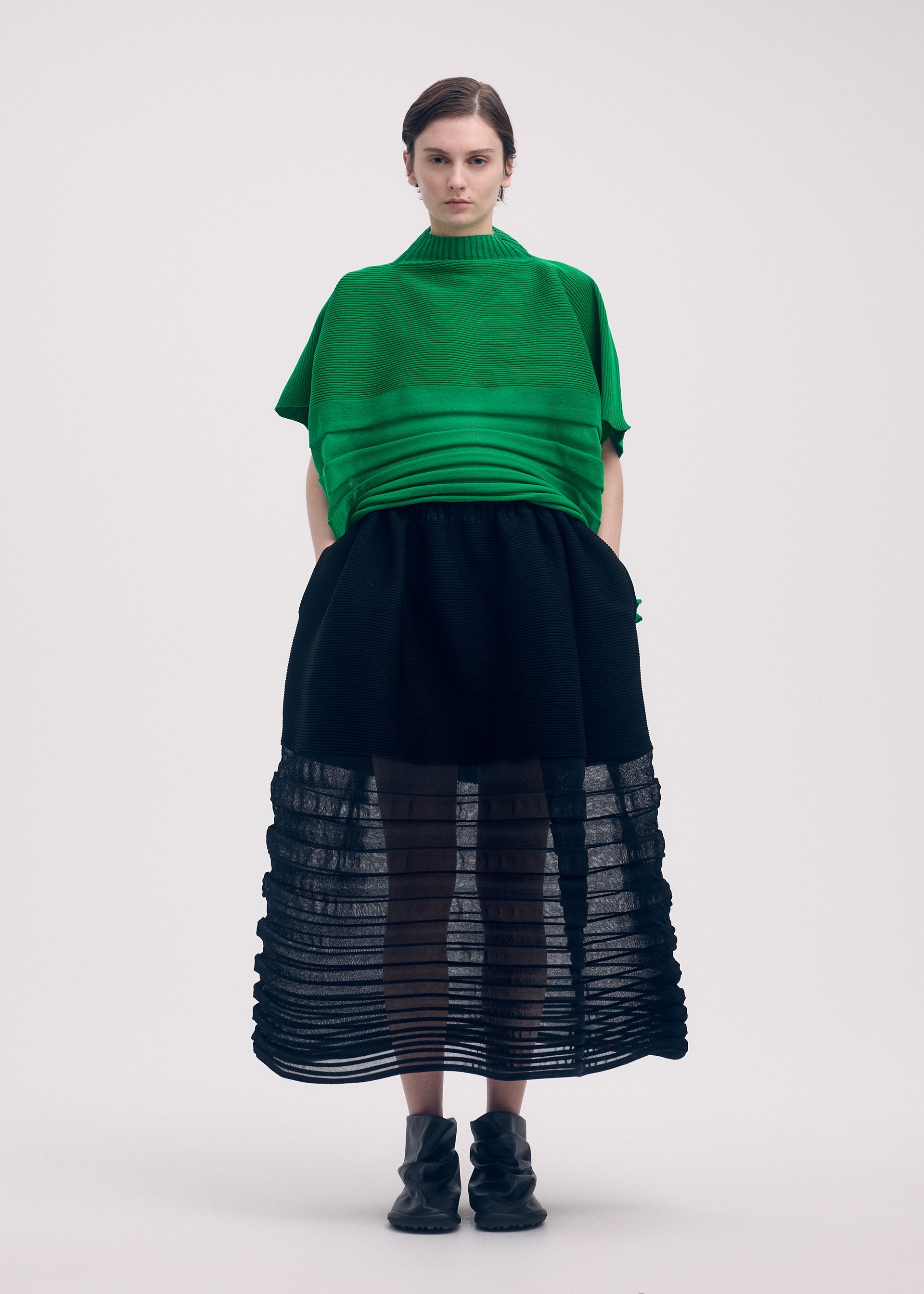 A model wears the ISSEY MIYAKE MOVING KNIT clothing.