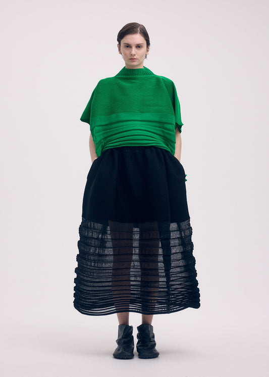 A model wears the ISSEY MIYAKE MOVING KNIT clothing.