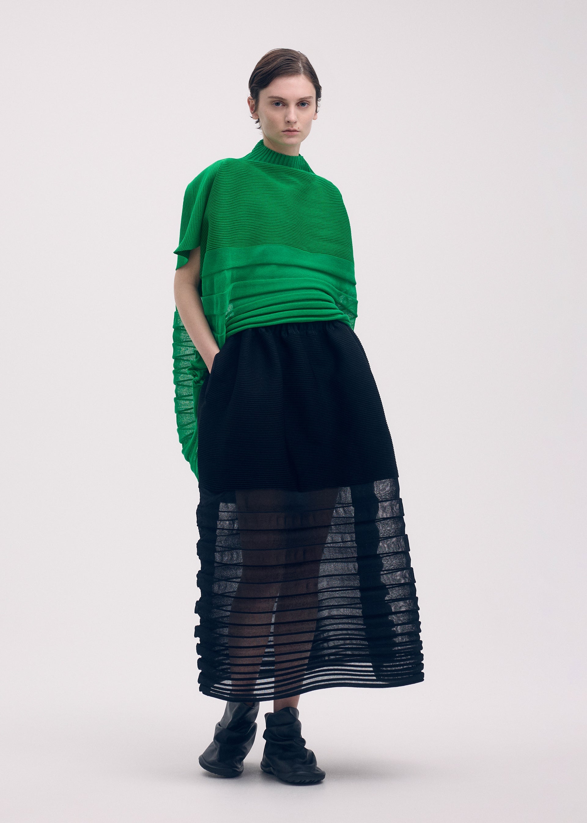 A model wears the ISSEY MIYAKE MOVING KNIT clothing.