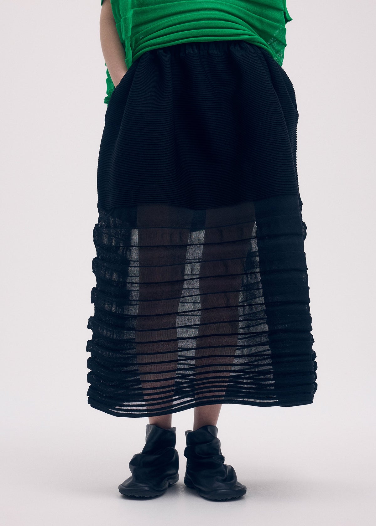 A model wears the ISSEY MIYAKE MOVING KNIT clothing.