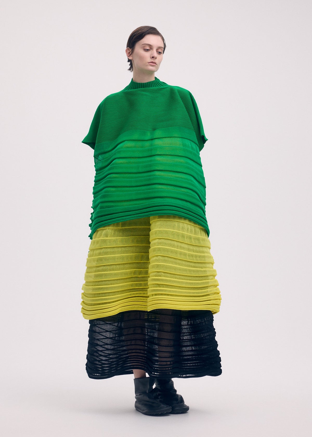 A model wears the ISSEY MIYAKE MOVING KNIT clothing.