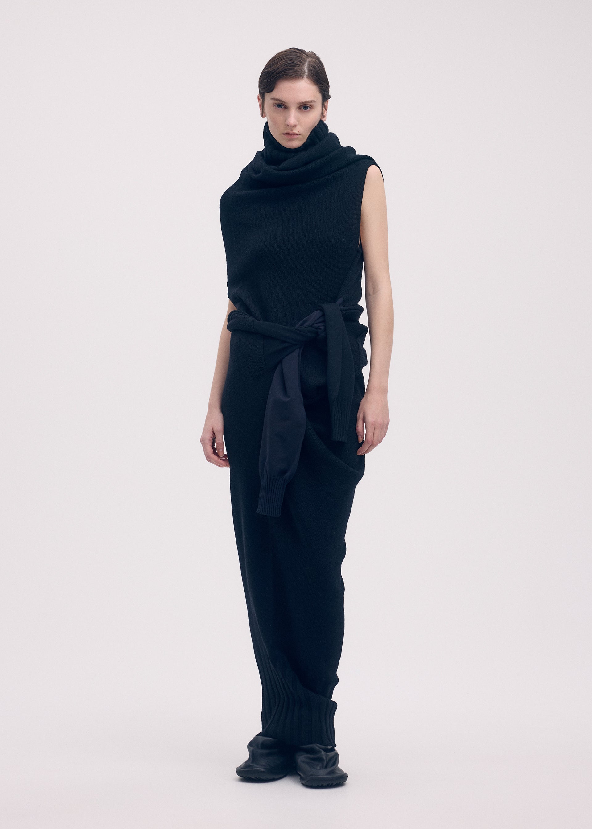A model wears the ISSEY MIYAKE SLEEVES COLLECTION dress.