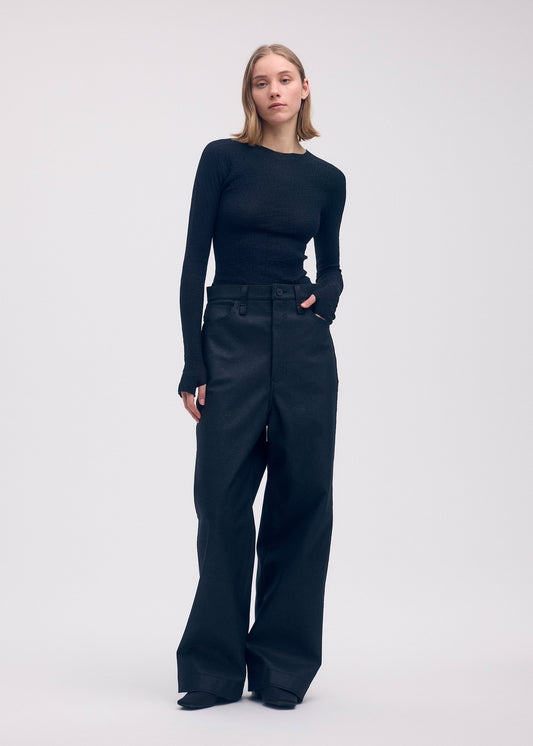 A model wears the ISSEY MIYAKE BODY KNIT top.