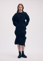 A model wears the ISSEY MIYAKE KONE KONE top.