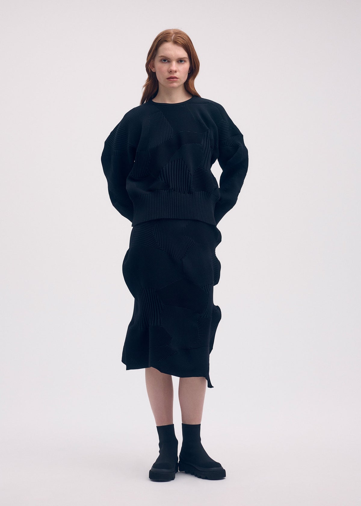 A model wears the ISSEY MIYAKE KONE KONE top.