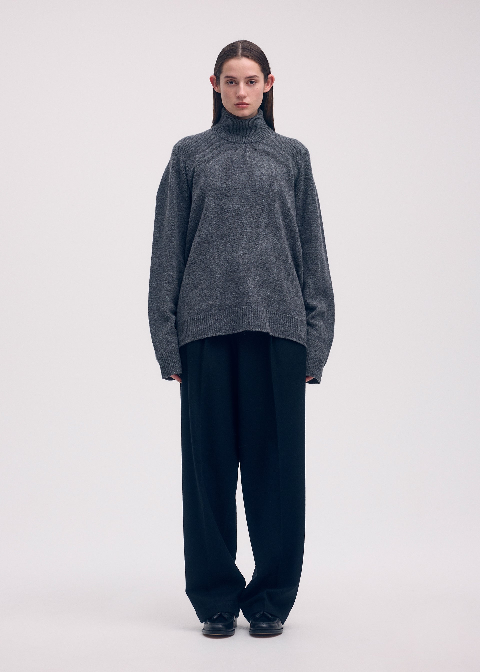 A model wears the ISSEY MIYAKE BACKPACK KNIT top.