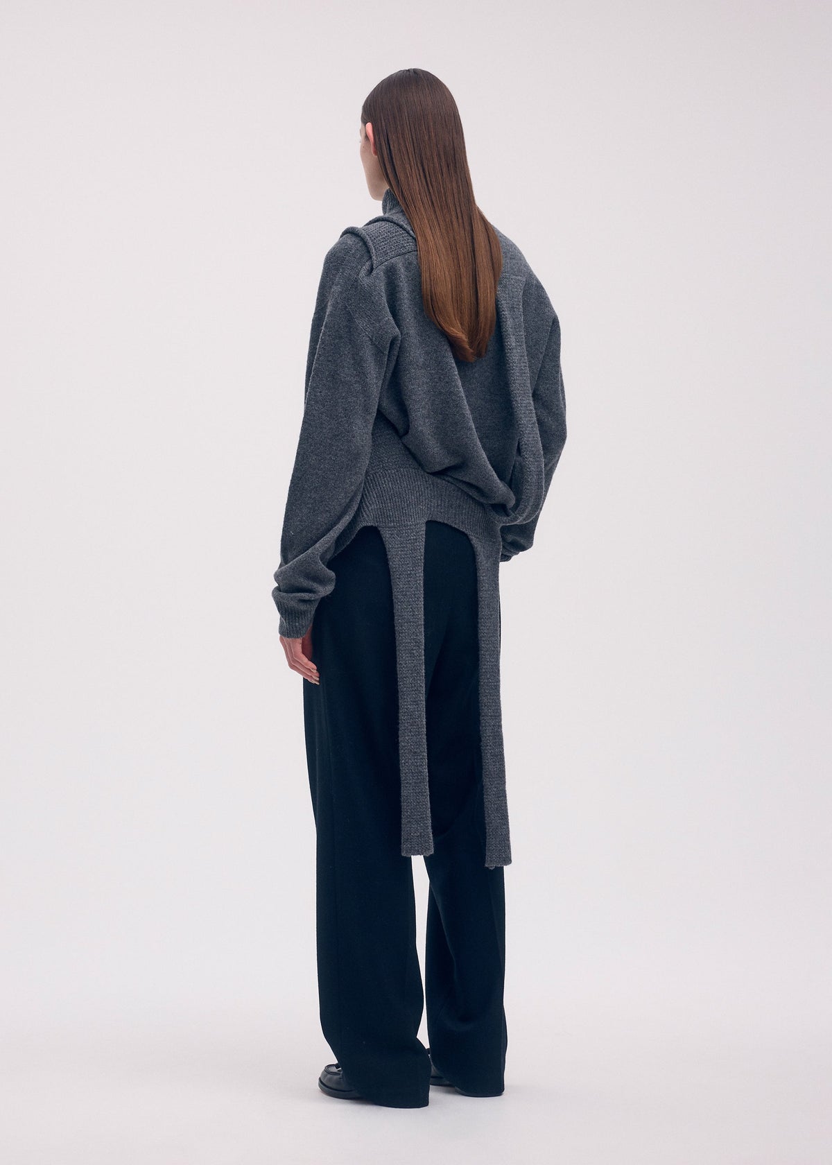 A model wears the ISSEY MIYAKE BACKPACK KNIT top.