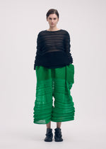 A model wears the ISSEY MIYAKE MOVING KNIT clothing.