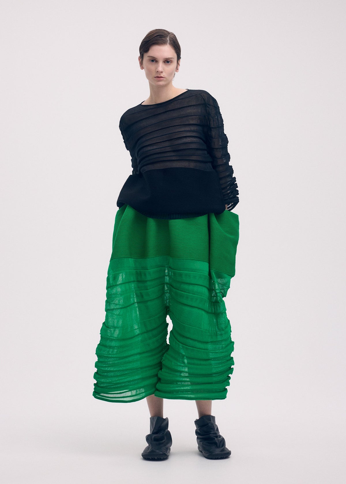 A model wears the ISSEY MIYAKE MOVING KNIT clothing.