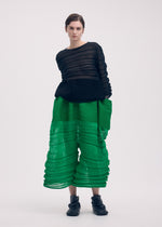 A model wears the ISSEY MIYAKE MOVING KNIT clothing.