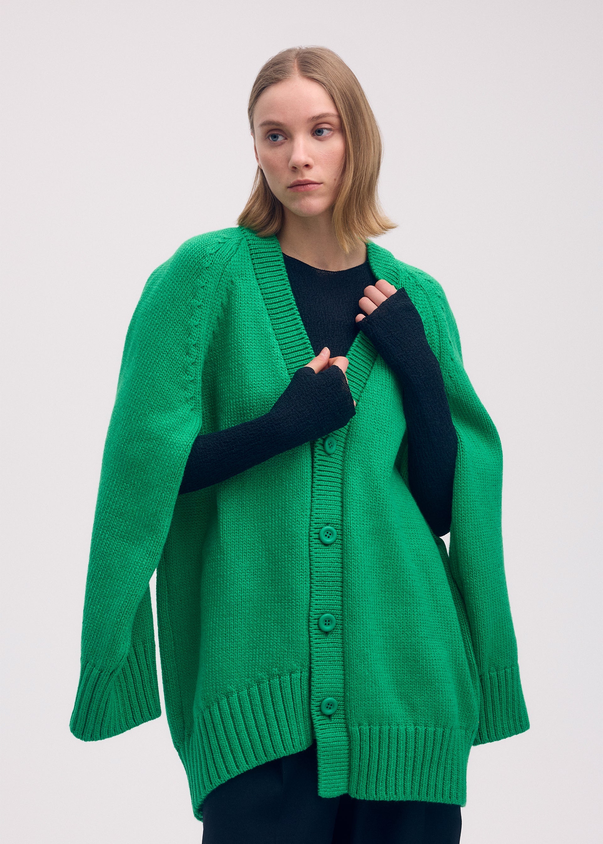 A model wears the ISSEY MIYAKE BREEZE KNIT cardigan.