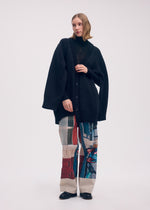 A model wears the ISSEY MIYAKE BREEZE KNIT cardigan.