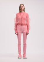 A model wears the ISSEY MIYAKE ENCASE cardigan.