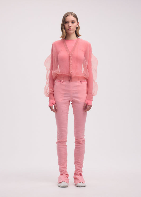 A model wears the ISSEY MIYAKE ENCASE cardigan.
