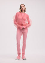 A model wears the ISSEY MIYAKE ENCASE cardigan.