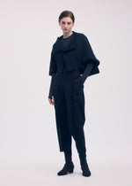 A model wears the ISSEY MIYAKE CAMPAGNE cardigan.
