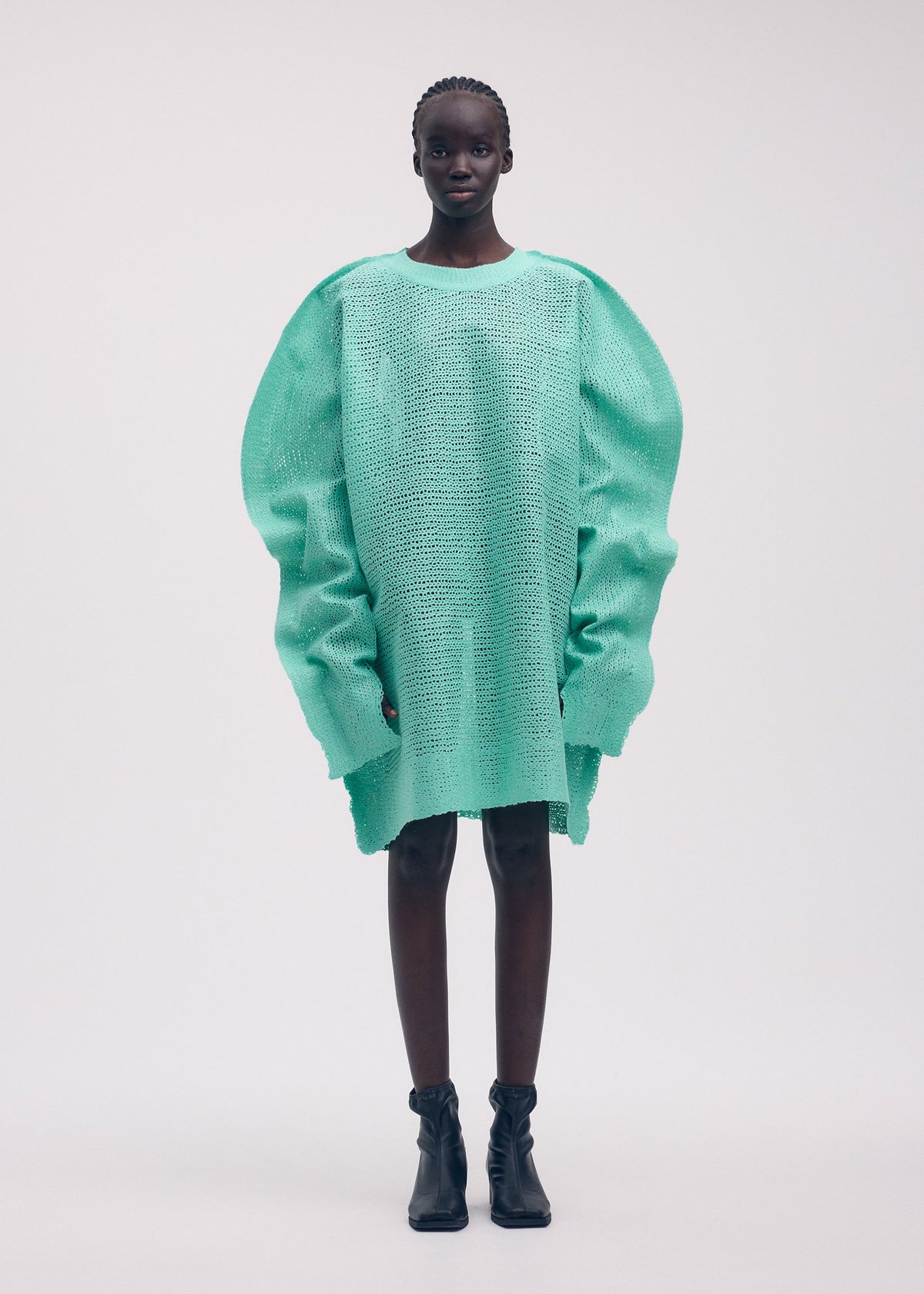 A model wears the ISSEY MIYAKE PANINI tunic.