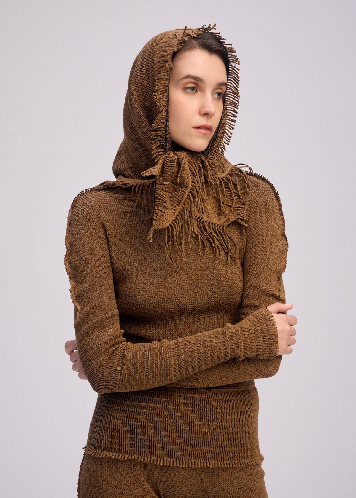 A model wears the ISSEY MIYAKE CROCHET AP STOLE stole.