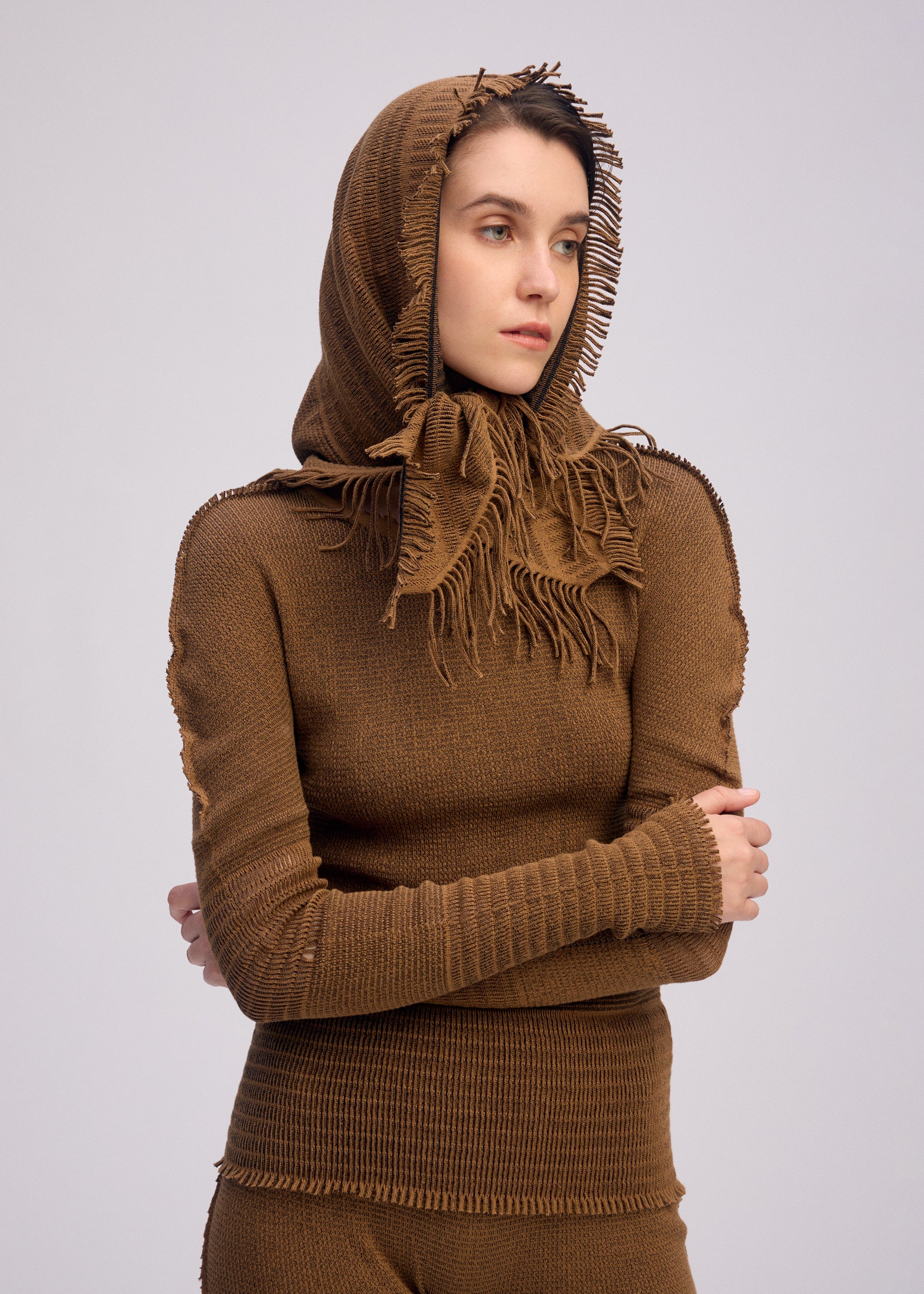 A model wears the ISSEY MIYAKE CROCHET AP STOLE stole.